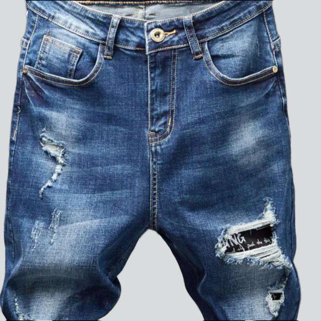 Destroyed blue jeans for men