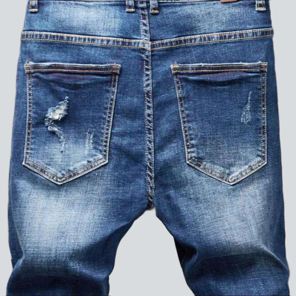 Destroyed blue jeans for men